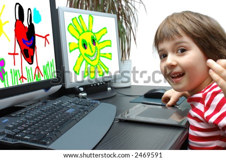 a girl 6 years old draws at the computer