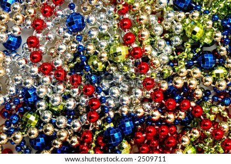 Very much beads on a table. coloured background