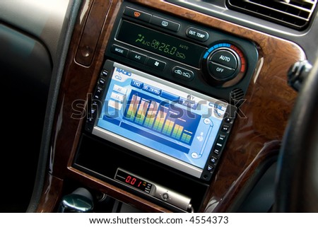 Modern luxury car interior, tv/dvd/audio system with monitor and climat control view.