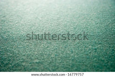 Green fabric background. Selected focus. Focus on a center photo.