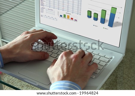 Caucasian man works on a white laptop. He are typing.