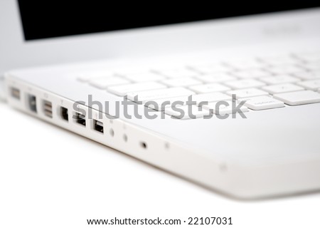 White laptop. Interface ports view on white background. Selective focus with short grip! Tilt view.