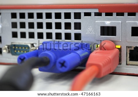 Network device, cable view. Red network cable pluged into ethernet port. Close-up. Adobe RGB color space.