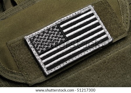 American flag on a green (olive drab) tactical vest. Close-up.