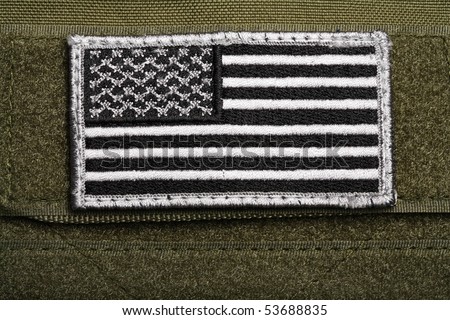 American military flag patch on a velcro, green background. Close-up shot.