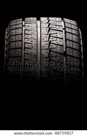 Brand new car tyre. Vertical composition.