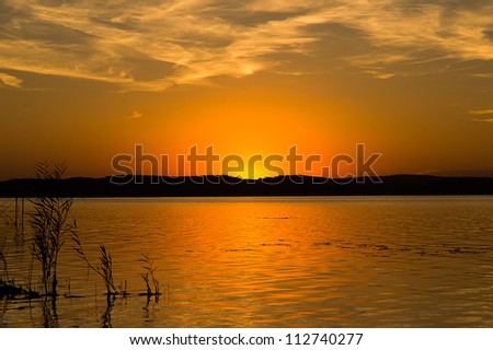 sunset with reeds and cloud veil,at Lake Balaton