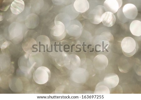 silver pearly white circle of light, defocused background