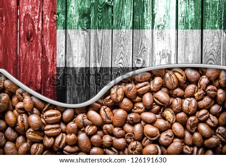 United Arab Emirates flag on wooden background and coffee beans wave