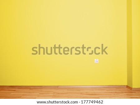 Empty Interior With Wooden Floor, Plug And Yellow Wall