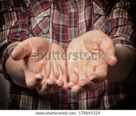 Dirty Outstretched Hands - Fingers closed Dirty outstretched male hands against black background - one hand laid on top of the other