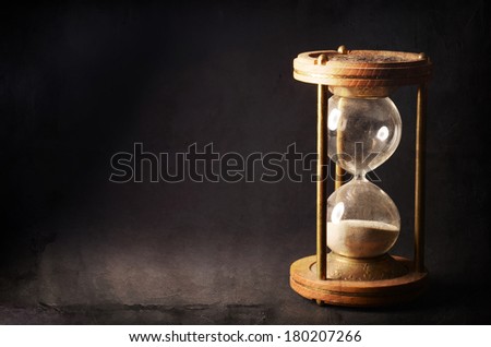 time concept with hourglass lying toned in warm black and white