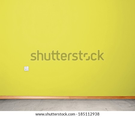 interior room with concrete floor and wall in yellow with an electrical contact in the wall