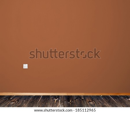 interior room with wooden floor and wall in brown with an electrical contact in the wall