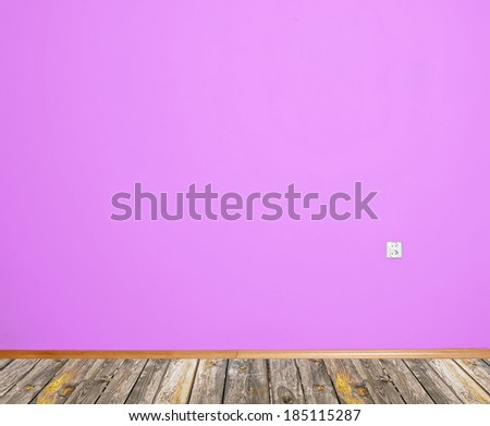 room interior with pink wallpaper with wooden skirting
