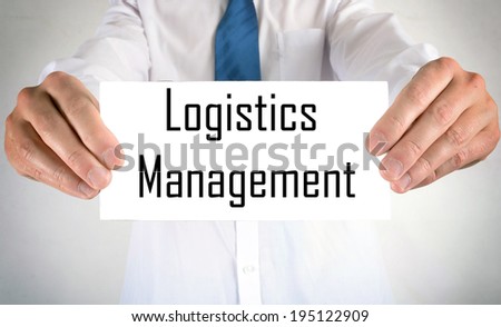 Businessman holding or showing card with Logistics Management