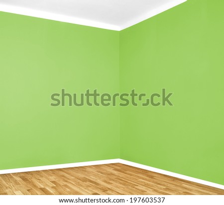empty room corner with wooden floor and green wall
