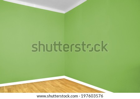 empty room corner with wooden floor and green wall