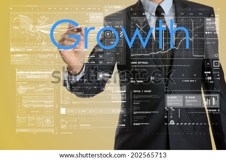 businessman writing growth concept and drawing some diagrams and graphs