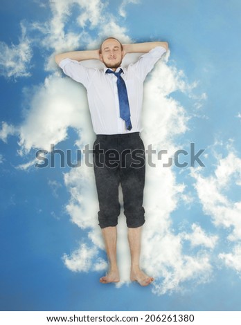 Businessman relaxing in a cloud