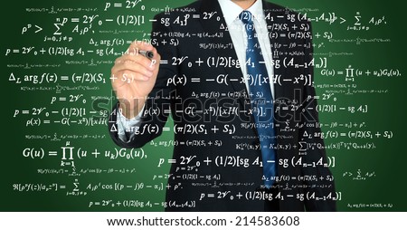 businessman handwriting mathematical operation on a transparent board