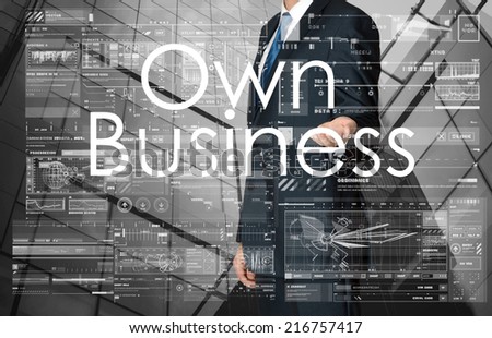 businessman presenting Own Business text and graphs and diagrams with skyscraper in background