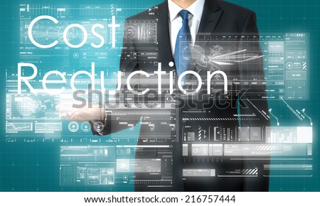 businessman presenting Cost Reduction text and graphs and diagrams with skyscraper in background