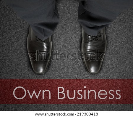 A business man is looking down at his feet with a red race line that says Own Business