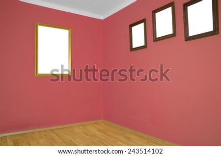 empty interior with wooden floor, frames on wall and pale red wall