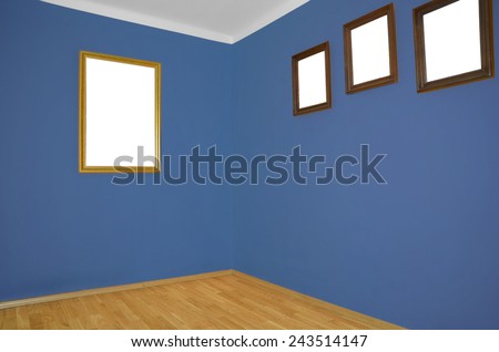 empty interior with wooden floor, frames on wall and blue wall