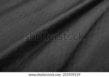 Black background resembling cloth, canvas, paint, silk or satin material with waving lines