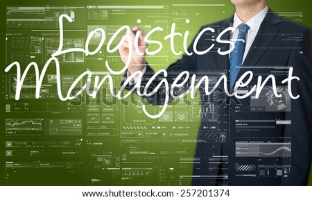 businessman writing Logistics Management on transparent board