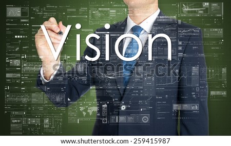 the businessman is writing Vision on the transparent board with some diagrams and infocharts