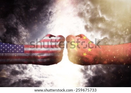 Two fists hitting each other over dark sky, Usa and China conflict