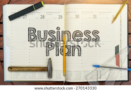notebook with the note in the center about the Business Plan