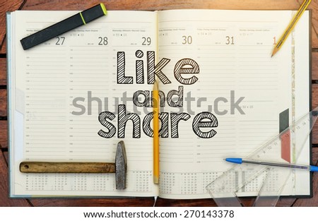 notebook with the note in the center Like and Share