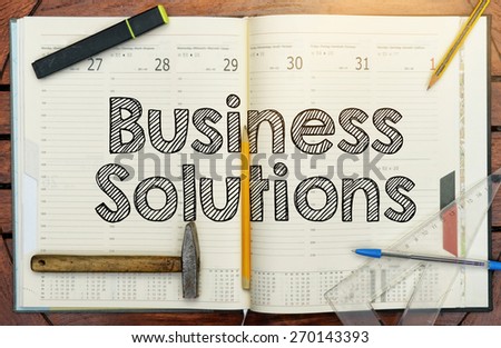 notebook with the note in the center about Business Solutions