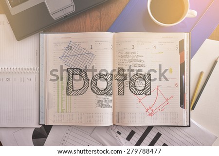 Notebook with text inside Data on table with coffee, some diagrams on paper and laptop