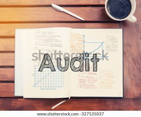 Audit : text inside notebook on table with coffee