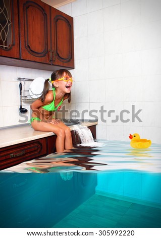 Child girl make mess, flooded kitchen imitating swimming pool, funny concept