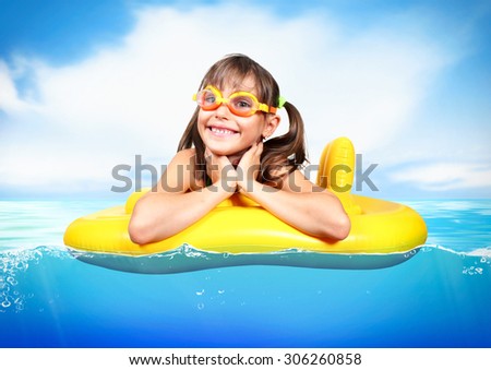 Funny child floating inflatable ring at sea, vacation concept