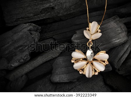 jewelry pendant with gems on darck background