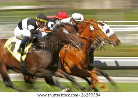 Slow shutter speed rendering of a group of racing jockeys and horses