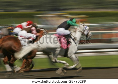 Slow shutter speed rendering of racing jockeys and horses