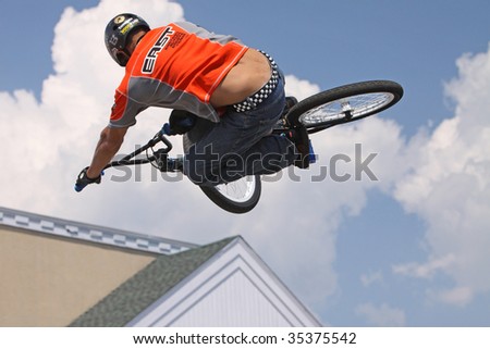 MILFORD, CT - AUG 16: Hector Restrepo performs high-flying BMX stunts at a performance by Eastern Action Sports Teams in Milford, CT, on August 16, 2009. BMX biking became an Olympic sport last year.