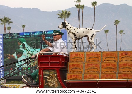 ARCADIA, CA - DEC 26: Drivers of the Clydesdale-drawn Budweiser Beer Wagon wave to fans at Santa Anita Park during an Opening Day celebration on Dec 26, 2009, Arcadia, CA.