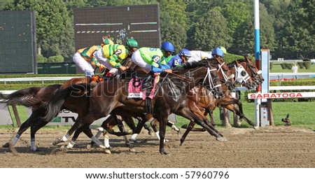 SARATOGA SPRINGS, NY - JUL 24: The field for the Coaching Club American Oaks makes its first pass by the Finish at Saratoga Race Course on Jul 24, 2010 in Saratoga Springs, NY.