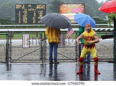 SARATOGA SPRINGS - JUL 23: An Opening Day downpour does not dampen the spirits of some horse racing fans at Saratoga Race Course on Jul 23, 2010 in Saratoga Springs, NY.