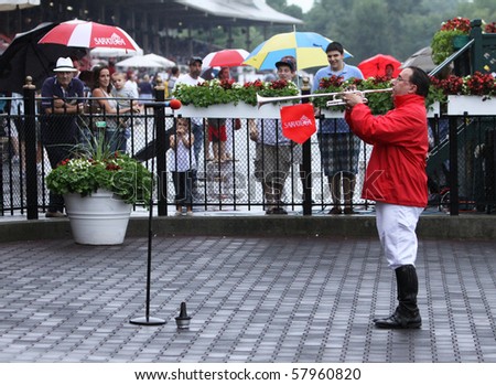 SARATOGA SPRINGS, NY - JUL 23: Sam the bugler plays the call to post on a rainy Opening Day at Saratoga Race Course on Jul 23, 2010 in Saratoga Springs, NY.