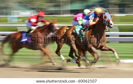 SARATOGA SPRINGS, NY - AUG 27: A jockey takes his mount to the lead in a thoroughbred allowance race at Saratoga Race Course on Aug 27, 2010 in Saratoga Springs, NY.